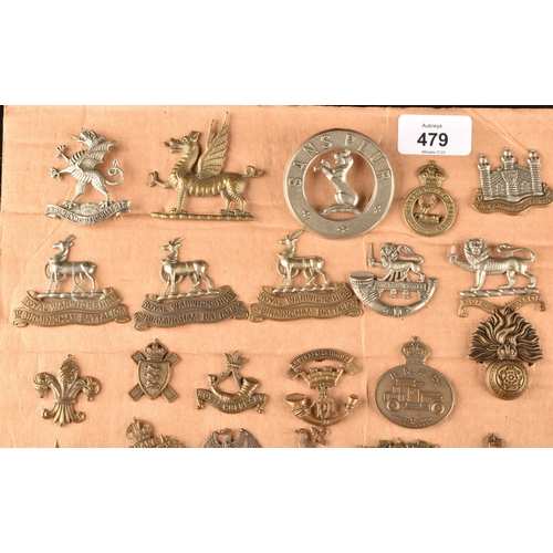 479 - A collection of military cap badges, including Monmouthshire Regiment, Hertfordshire Regiment, The C... 