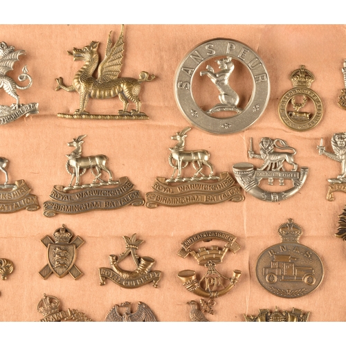 479 - A collection of military cap badges, including Monmouthshire Regiment, Hertfordshire Regiment, The C... 