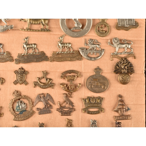 479 - A collection of military cap badges, including Monmouthshire Regiment, Hertfordshire Regiment, The C... 