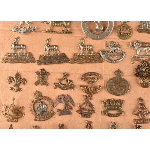 479 - A collection of military cap badges, including Monmouthshire Regiment, Hertfordshire Regiment, The C... 