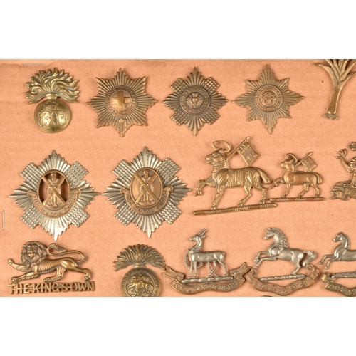 481 - A collection of military cap badges, including The Royal Scots Regiment, The Buffs, The Norfolk Regi... 