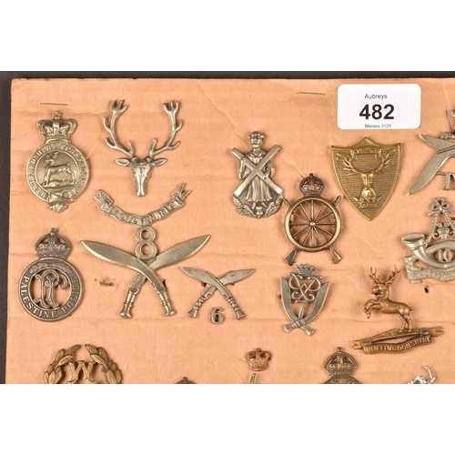 482 - A collection of military and police cap badges including Hertfordshire Constabulary, Palestine Polic... 