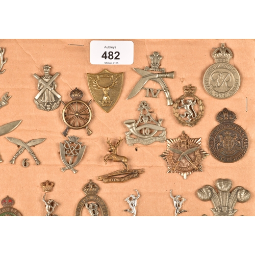 482 - A collection of military and police cap badges including Hertfordshire Constabulary, Palestine Polic... 