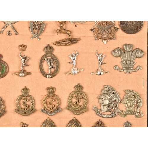 482 - A collection of military and police cap badges including Hertfordshire Constabulary, Palestine Polic... 