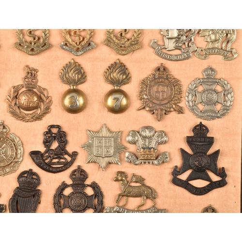 482 - A collection of military and police cap badges including Hertfordshire Constabulary, Palestine Polic... 