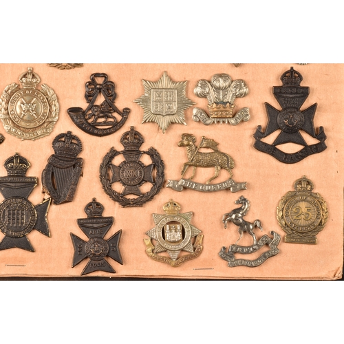 482 - A collection of military and police cap badges including Hertfordshire Constabulary, Palestine Polic... 