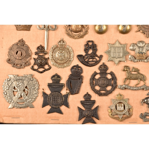 482 - A collection of military and police cap badges including Hertfordshire Constabulary, Palestine Polic... 