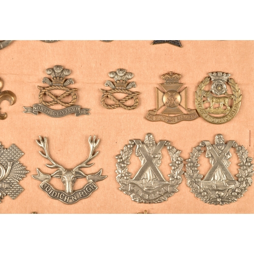 484 - A collection of military cap badges including Loyal North Lancashire Regiment, Northamptonshire Regi... 