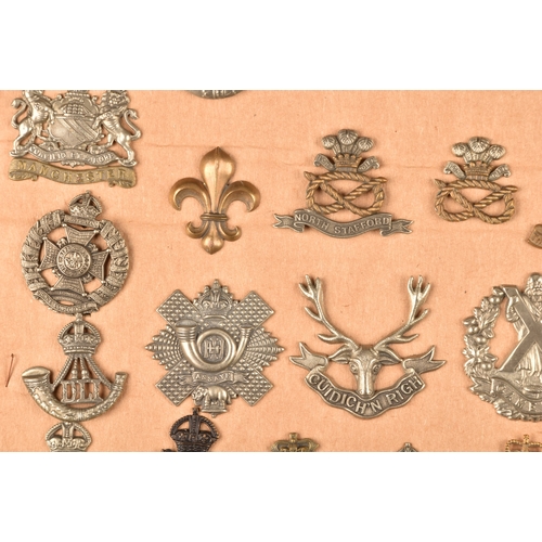 484 - A collection of military cap badges including Loyal North Lancashire Regiment, Northamptonshire Regi... 