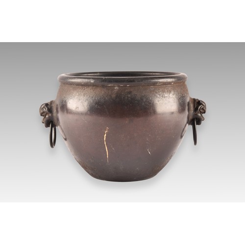 231 - An 18th century Chinese bronze bowl, with a rolled rim, dogs of foe handles, impressed Chinese chara... 