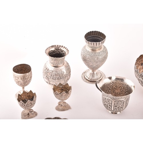 158 - A collection of Burmese white metal objects, including three dishes, a pair of spill vases, a pair o... 