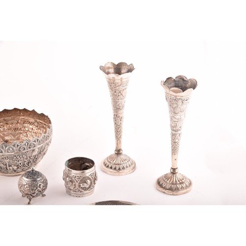 158 - A collection of Burmese white metal objects, including three dishes, a pair of spill vases, a pair o... 