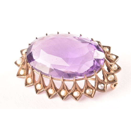 93 - A yellow metal Amethyst and pearl seed brooch, set to centre with a oval amethyst with an approximat... 