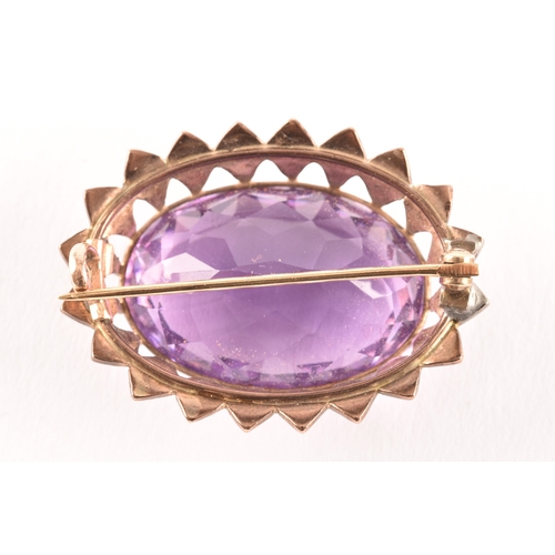 93 - A yellow metal Amethyst and pearl seed brooch, set to centre with a oval amethyst with an approximat... 