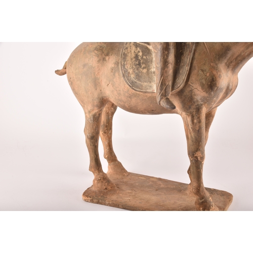 321 - A large Chinese Tang Dynasty painted pottery equestrian group of a horse and rider, the rider seated... 