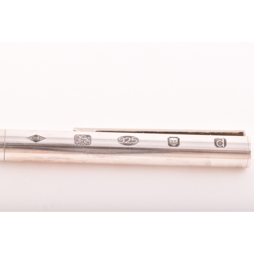 130 - A sterling silver slim ball point pen with feature large hallmarks for London 2003 by Braybrook &... 