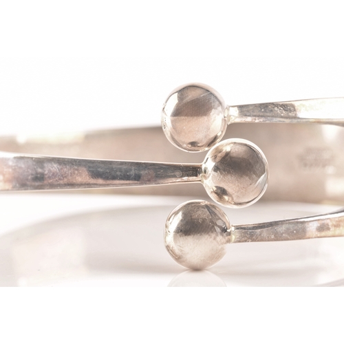 100 - A 1960's Norwegian silver three ball bangle by Anna Greta Eker, 7cm diameter.