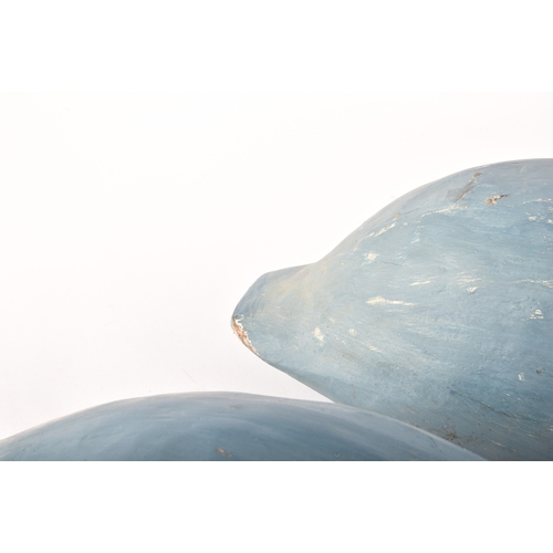 331 - A pair of blue painted carved wooden birds, possibly Grebes, in seated / swimming position.