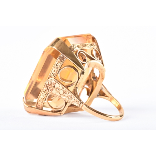 102 - A vintage 18ct yellow gold cocktail ring, set to centre with a octagonal citrine measuring approxima... 