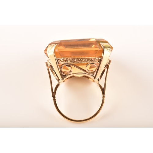 102 - A vintage 18ct yellow gold cocktail ring, set to centre with a octagonal citrine measuring approxima... 