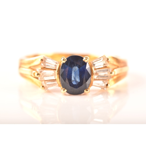 107 - A 18ct yellow gold sapphire and diamond ring, set to centre with a oval sapphire with an approximate... 