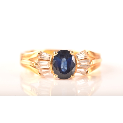 107 - A 18ct yellow gold sapphire and diamond ring, set to centre with a oval sapphire with an approximate... 