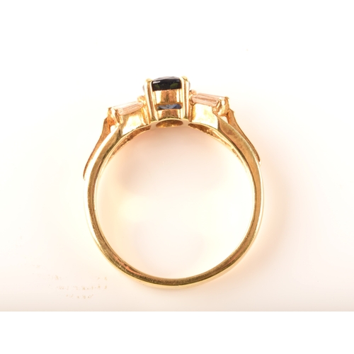 107 - A 18ct yellow gold sapphire and diamond ring, set to centre with a oval sapphire with an approximate... 