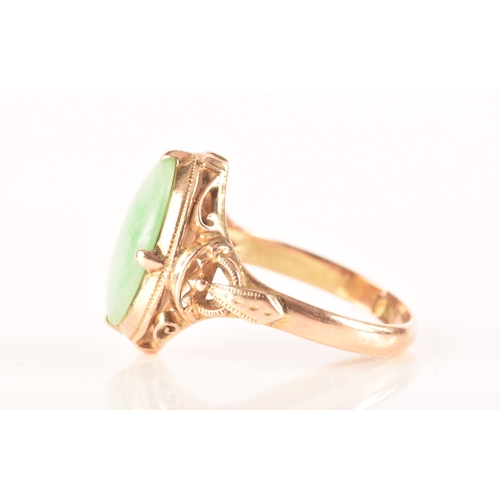 113 - A yellow metal dress ring, set with a cabochon oval jade measuring approximately 14mm length x 10.5m... 