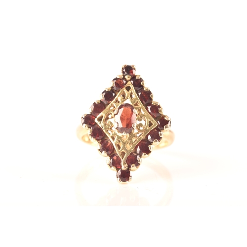 115 - A 9ct yellow gold marquise cluster ring, set to centre with a oval garnet, surrounded by round garne... 