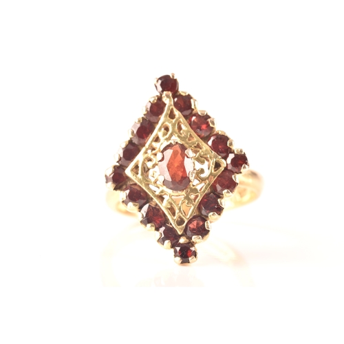 115 - A 9ct yellow gold marquise cluster ring, set to centre with a oval garnet, surrounded by round garne... 