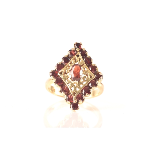 115 - A 9ct yellow gold marquise cluster ring, set to centre with a oval garnet, surrounded by round garne... 