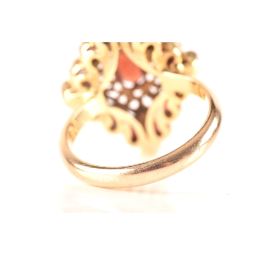 115 - A 9ct yellow gold marquise cluster ring, set to centre with a oval garnet, surrounded by round garne... 