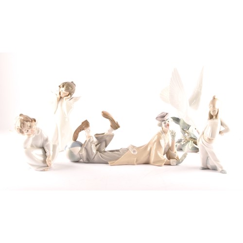 262 - A group of Lladro figures, including a daydreaming angel, a clown, a mime angel, a large turtle dove... 