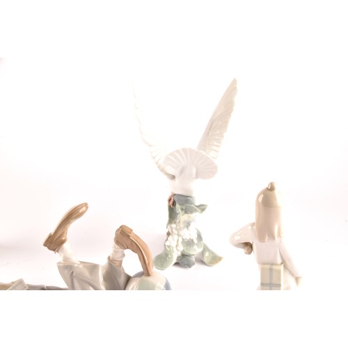 262 - A group of Lladro figures, including a daydreaming angel, a clown, a mime angel, a large turtle dove... 