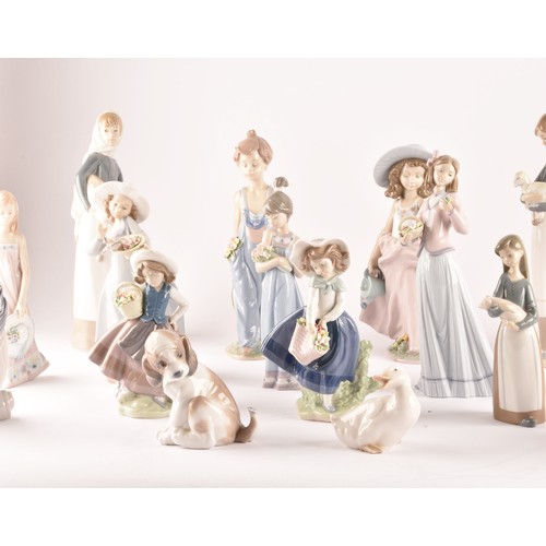 264 - A large collection of Lladro, including fourteen female figurines, a puppy, a Lladro society scroll,... 