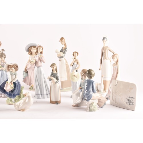 264 - A large collection of Lladro, including fourteen female figurines, a puppy, a Lladro society scroll,... 