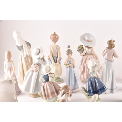 264 - A large collection of Lladro, including fourteen female figurines, a puppy, a Lladro society scroll,... 