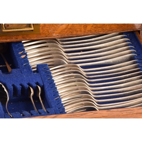 170 - An early 20th century oak cased canteen of cutlery, with three drawers including twelve places setti... 