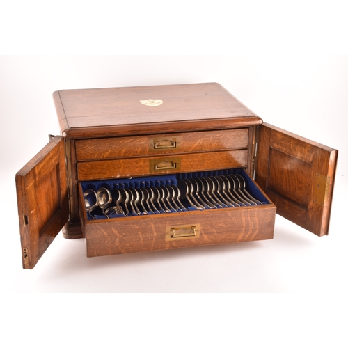 170 - An early 20th century oak cased canteen of cutlery, with three drawers including twelve places setti... 