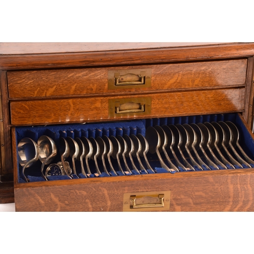 170 - An early 20th century oak cased canteen of cutlery, with three drawers including twelve places setti... 