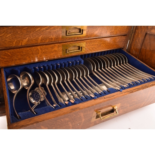 170 - An early 20th century oak cased canteen of cutlery, with three drawers including twelve places setti... 