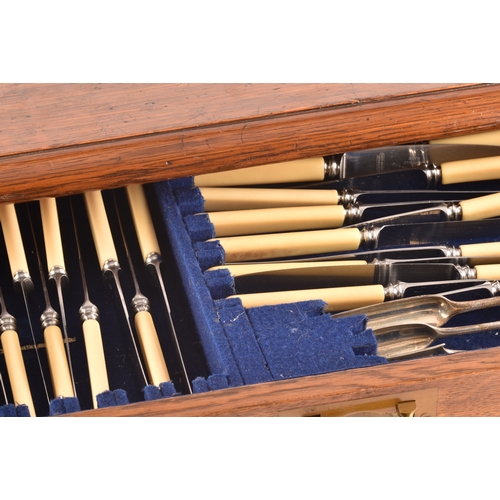 170 - An early 20th century oak cased canteen of cutlery, with three drawers including twelve places setti... 