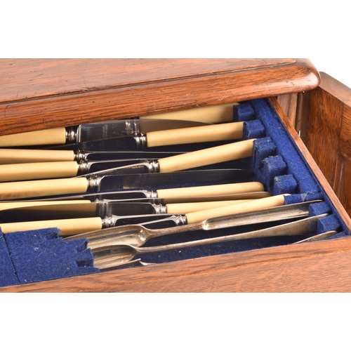 170 - An early 20th century oak cased canteen of cutlery, with three drawers including twelve places setti... 