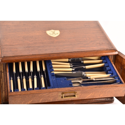 170 - An early 20th century oak cased canteen of cutlery, with three drawers including twelve places setti... 