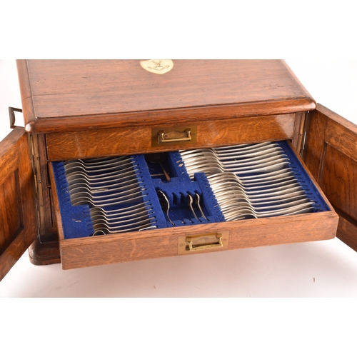 170 - An early 20th century oak cased canteen of cutlery, with three drawers including twelve places setti... 