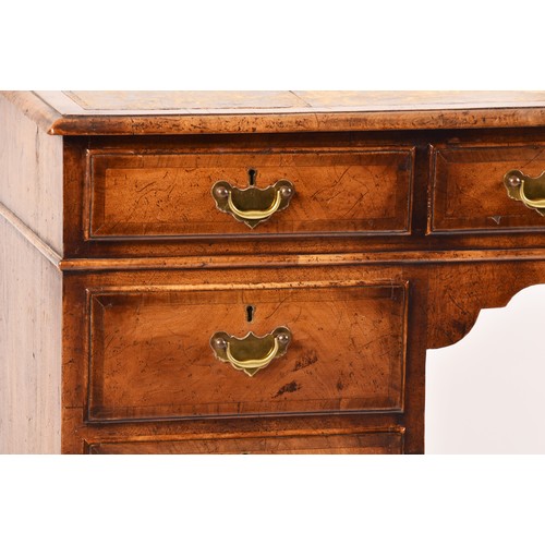 292 - An early 20th century walnut pedestal desk, the tooled brown leather top, over three frieze drawers,... 