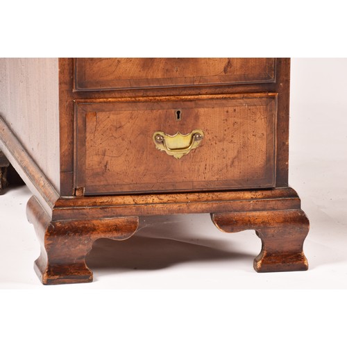 292 - An early 20th century walnut pedestal desk, the tooled brown leather top, over three frieze drawers,... 