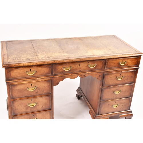 292 - An early 20th century walnut pedestal desk, the tooled brown leather top, over three frieze drawers,... 