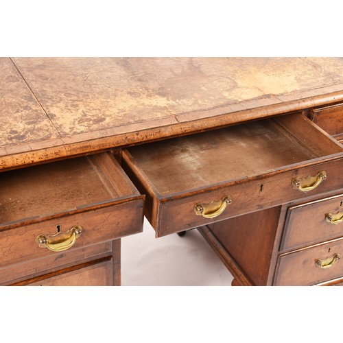 292 - An early 20th century walnut pedestal desk, the tooled brown leather top, over three frieze drawers,... 