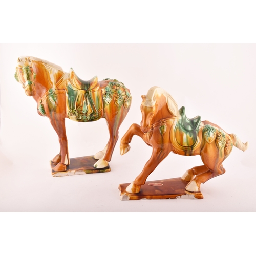 239 - A pair of Chinese Tang Dynasty Sancai style glazed ceramic war horses, 20 cm high.